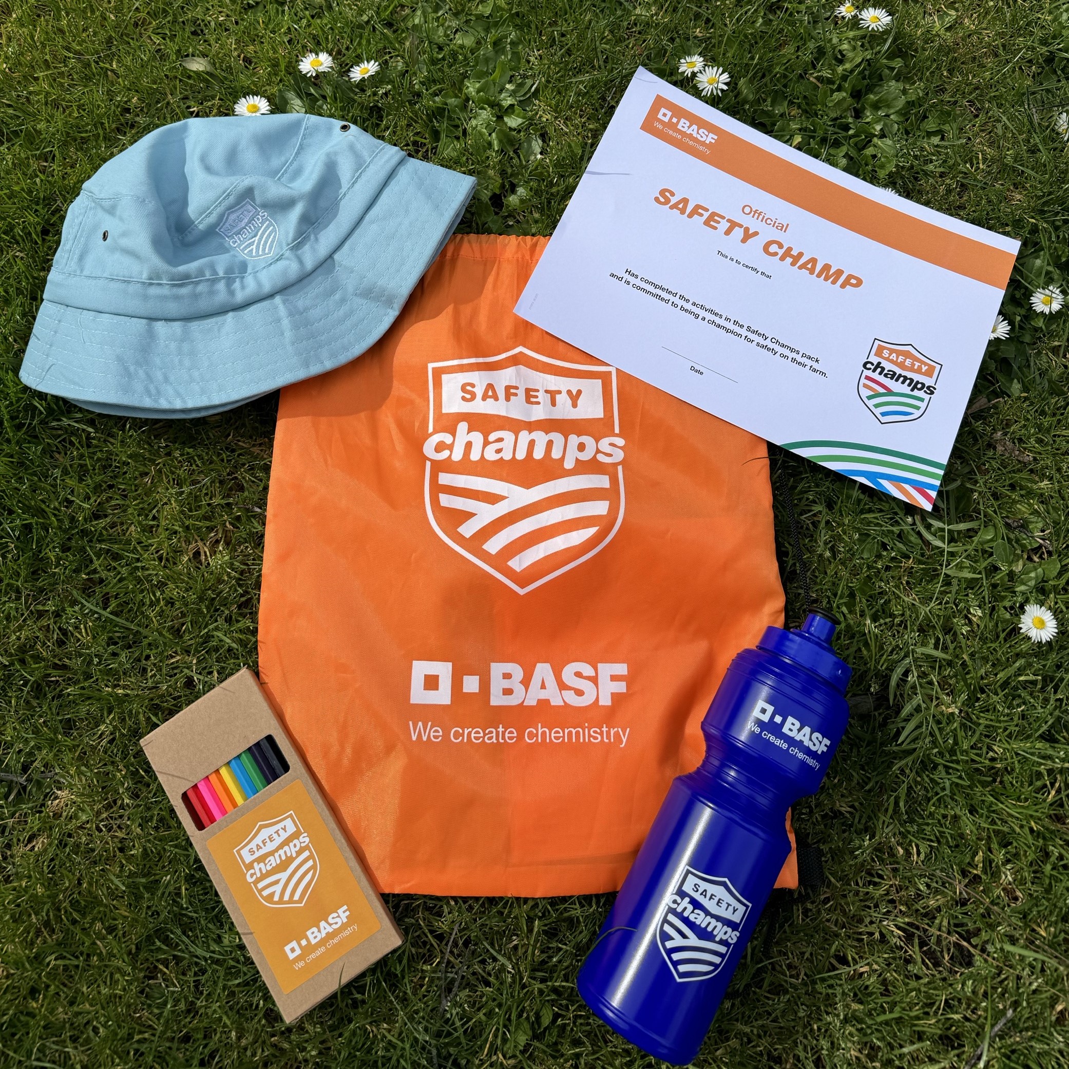 Safety Champs pack including an orange bag, coloured pencils, certificate, blue drink bottle and light blue hat